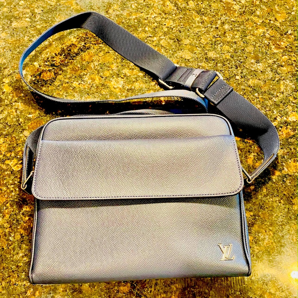 This is a brand new authentic Louis Vuitton Alex Messenger PM bag in Taiga Blue.